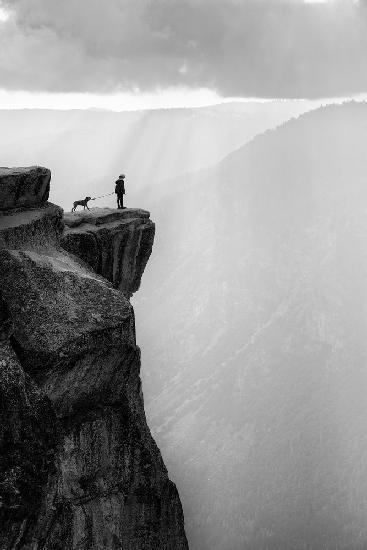 Woman and dog on cliff