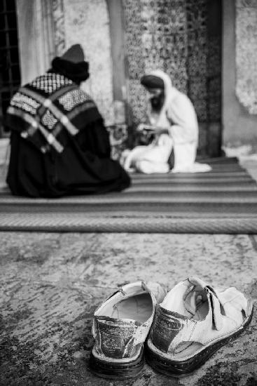 men praying in mosque