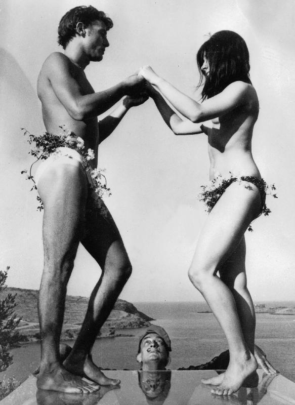 Salvador Dali looking at his models standing on thick glass plate posing for new painting of Sardana van English Photographer, (20th century)