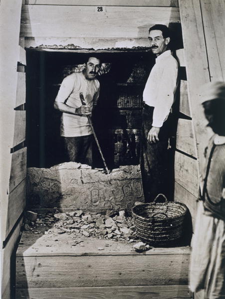 Howard Carter (1873-1939) and a colleague standing beside a partially demolished wall to one of the  van Harry Burton