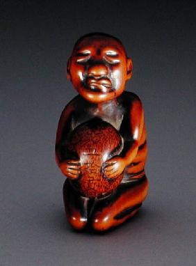 Netsuke of a blind masseur lifting a stone