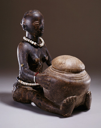 A Luba Figure Of A Seated Female Holding A Round Bowl van 