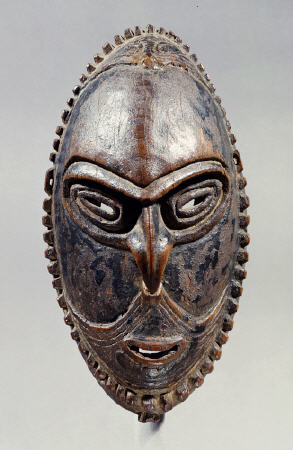 A New Guinea Mask Of Oval Form With Pierced Eyes, Mouth And Septum van 