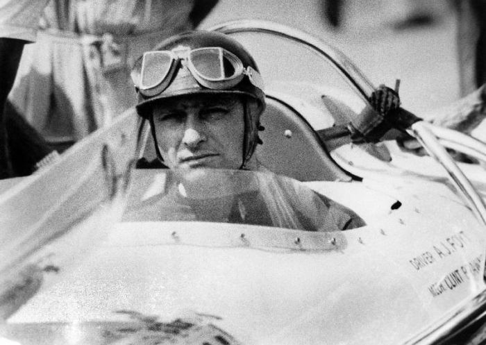 racing driver Fangio here at the wheel during race in Monza van 