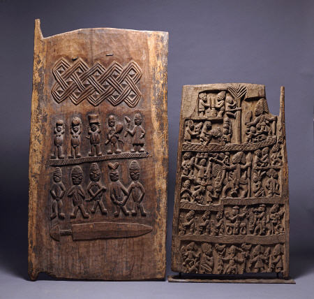 Two Yoruba Doors, One For A Shango Shrine, Both Carved In Relief With Various Figures van 