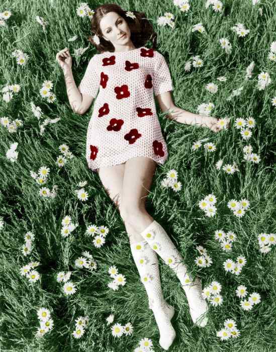 Young model Biddy Lampard in the grass wearing a short dress inspired by Courreges colourized docume van 