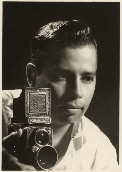 Orlando Suero portrait with Rolleiflex camera, c van Orlando Suero
