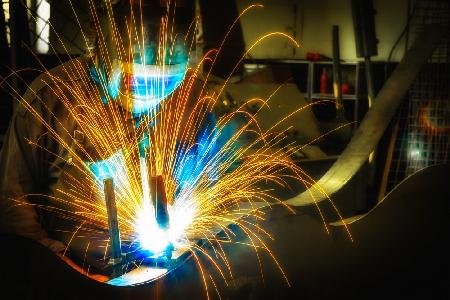 Artist welding steel sculpture